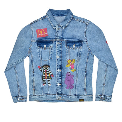 Denim jacket with printed Hamburglar, Grimace, and Birdie characters on body and Golden Arches on chest