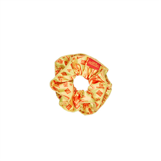 Yellow scrunchie with printed repeated egg McMuffin pattern in red