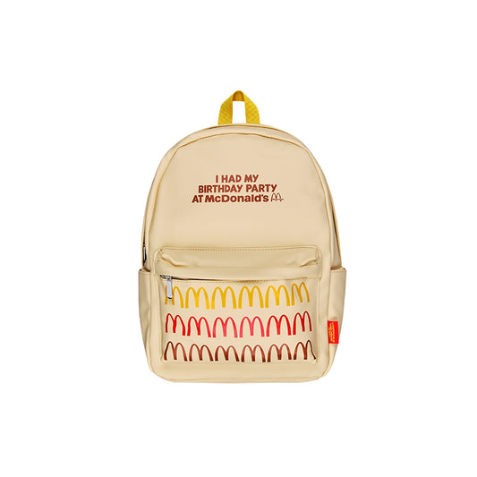 Beige backpack with I had my Birthday party at McDonald's printed in brown. Repeated Golden Arches pattern on pocket in Yellow, red and brown. 